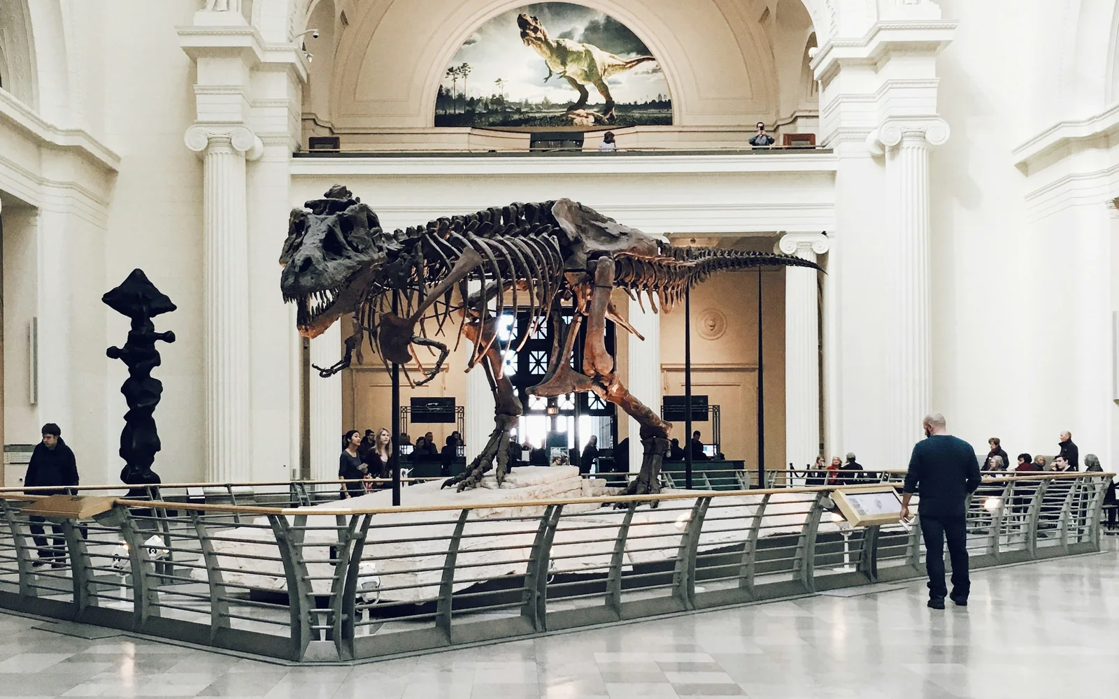 Children and adults participating in a gamified activity in a museum.